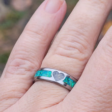 Load image into Gallery viewer, This titanium ring is small yet durable. It is 6mm wide and shows the unique ashes next to the bright colors of the green opals.